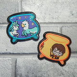 Two embroidered  coaster with fantasy creatures and a wizard; one depicts a unicorn and stars, the other a dragon and a pot with a handle.